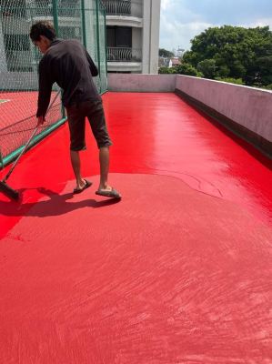 Application of 2nd coat of acrylic colour coating by rubber squeegee tool in progress