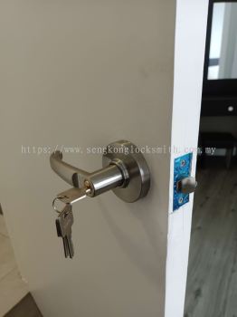 Professional locksmith installing door lock